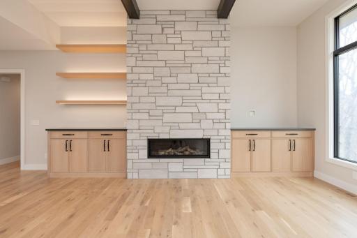 Stunning fireplace, cabinets, and shelving