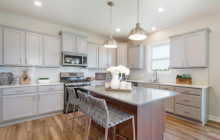 This spacious kitchen features a walk-in pantry, a large center island, stainless appliances, a luxurious gas cooktop and more!