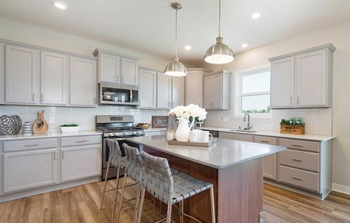 This spacious kitchen features a walk-in pantry, a large center island, stainless appliances, a luxurious gas cooktop and more!