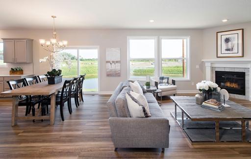 The spacious and open main level seamlessly connects to the kitchen area, perfect for entertaining. It also features many large windows providing abundant natural light.