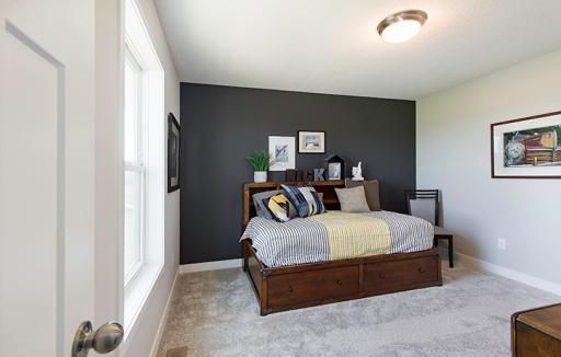 One of the three upper level secondary bedrooms with a spacious closet.