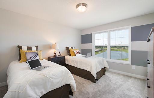 A second of the three upper level secondary bedrooms with a spacious closet.