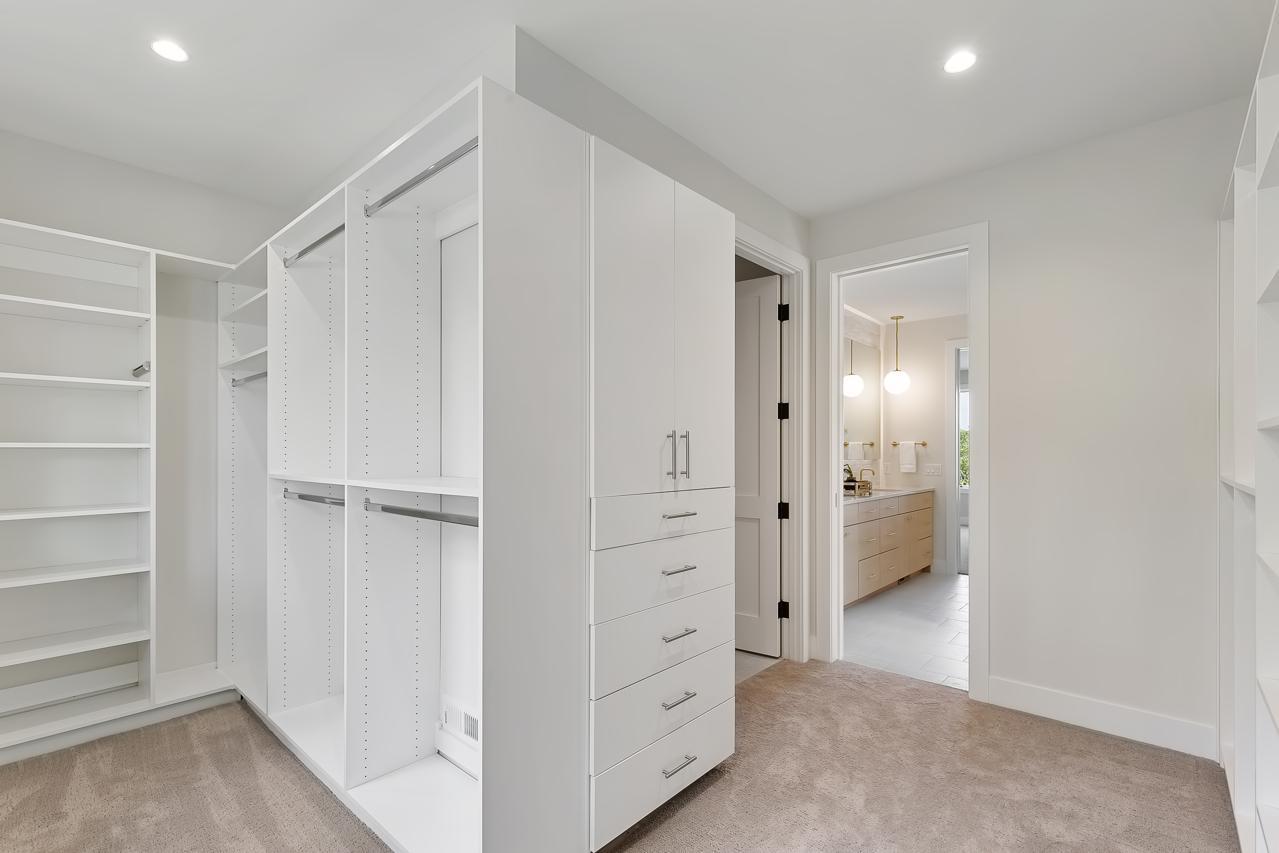 Primary suite closet with laundry access