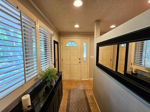 The side-entry door leads from the mud room to the outdoor hot tub and deck.