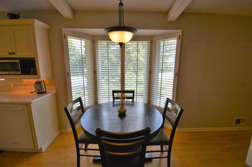 The dining area opens to the kitchen with counter seating, where you can enjoy your morning coffee while looking out at the beautifully landscaped yard.
