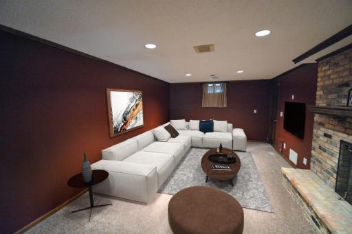 The lower level family room is the perfect place to watch a movie and features a fireplace and plenty of outlets for all your media.