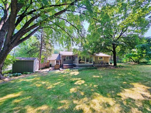 The rear of the home is stately, with the 3-season porch connecting the home to the outdoors.