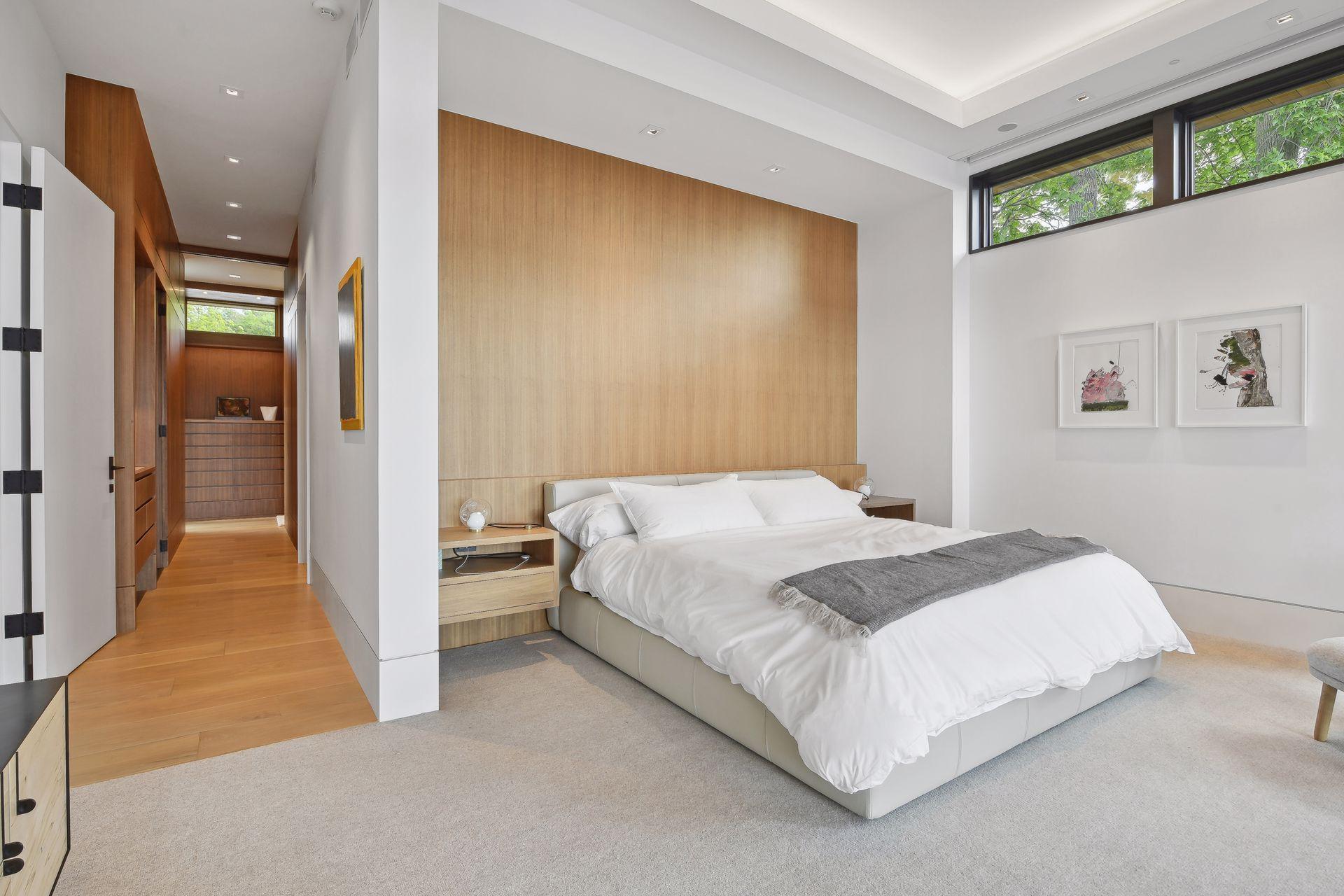 Primary bedroom with walnut veneered wall