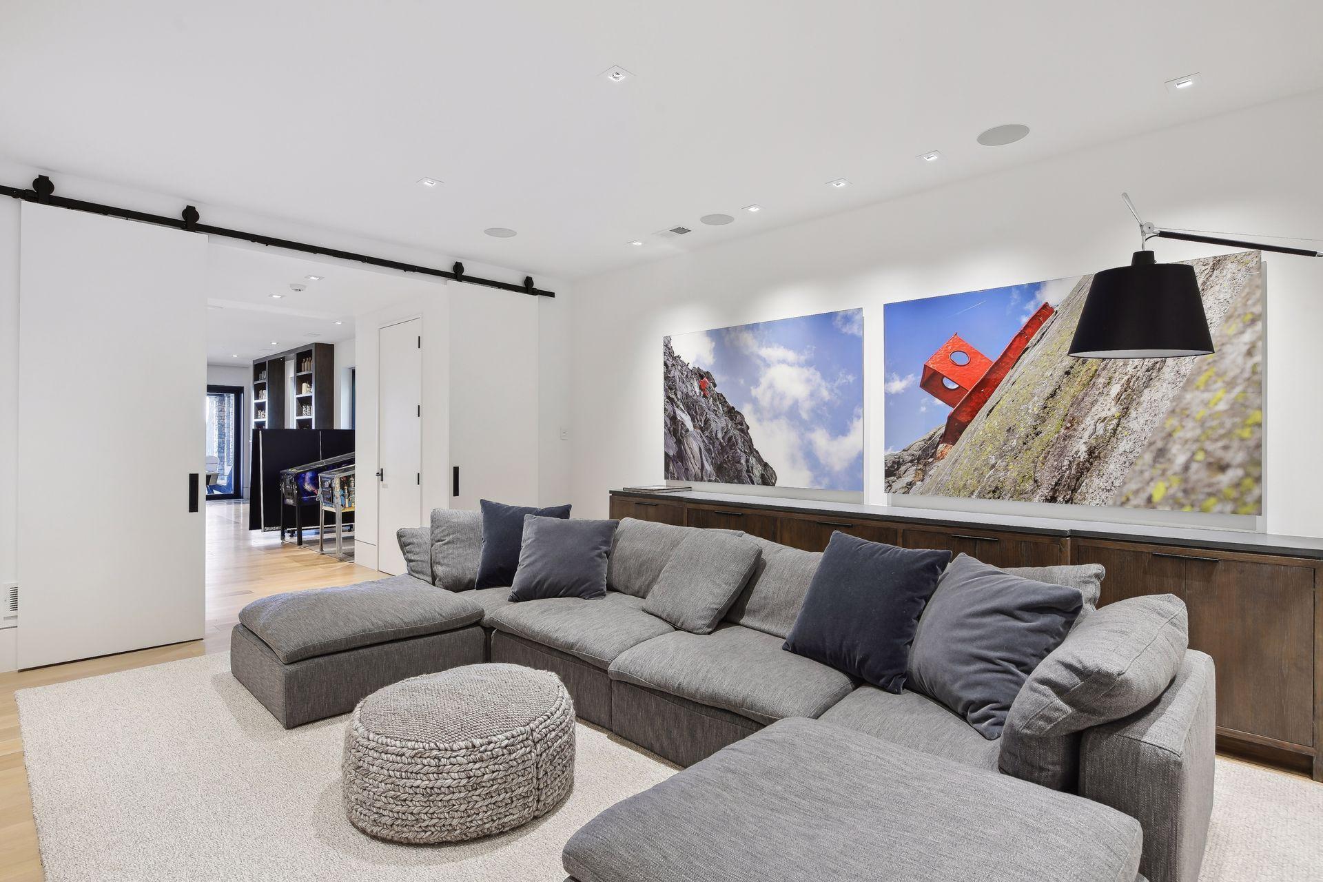 Lower level tv room with barn doors for privacy and sound control