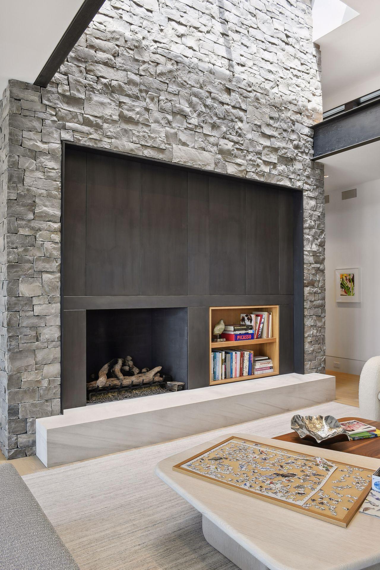 Steel, stone and wood create a stunning fireplace