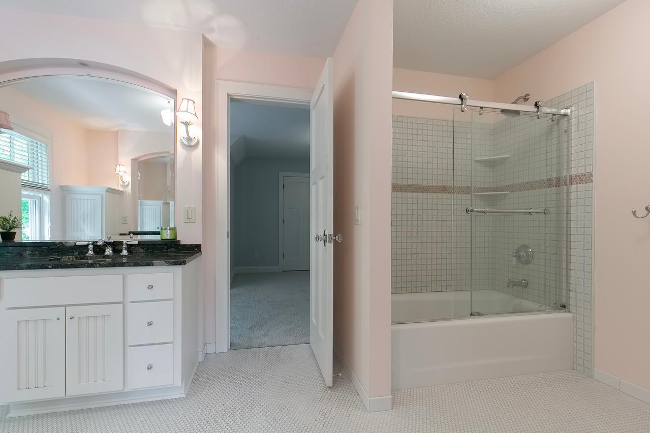 Upper level bathroom with tub and shower