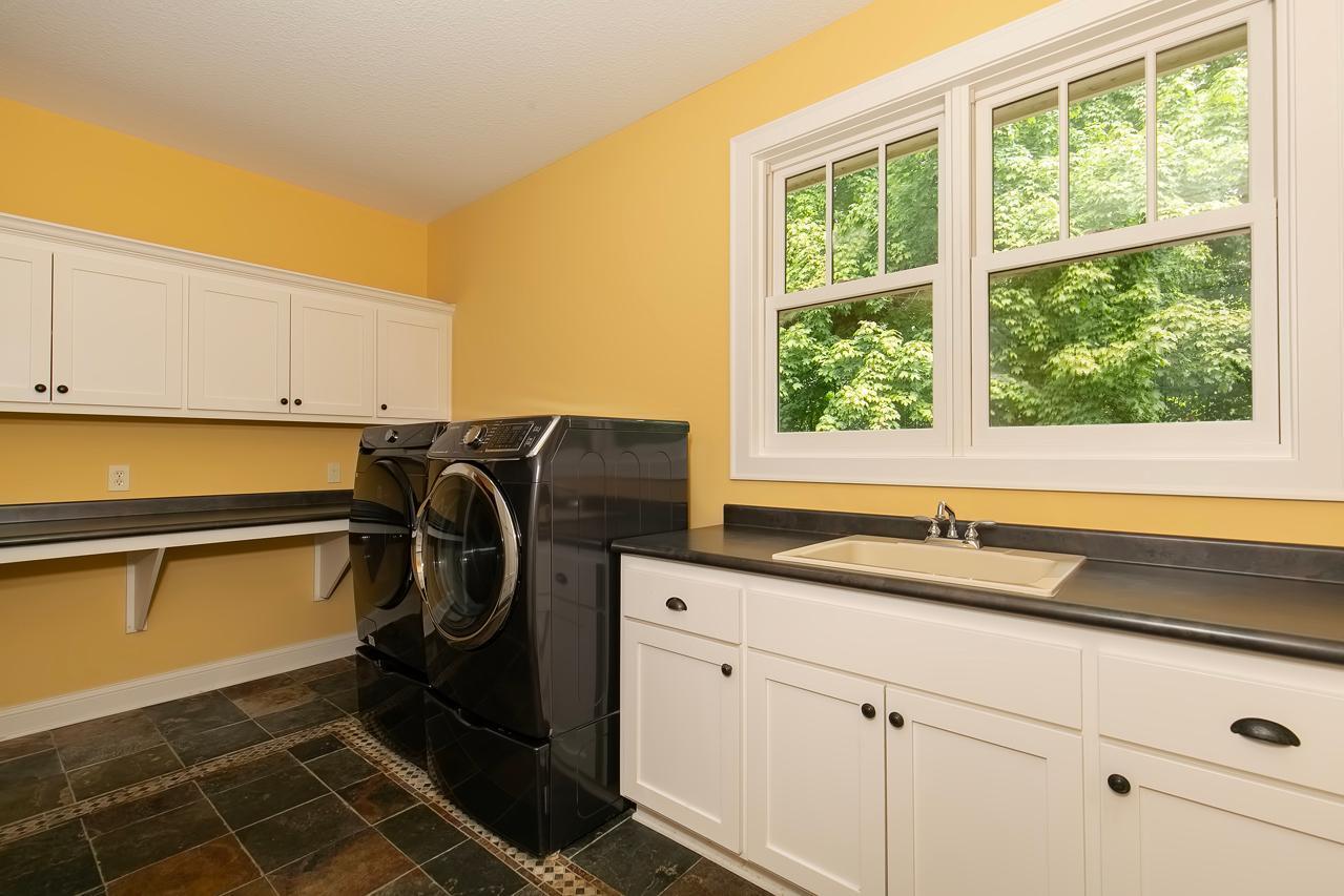 Main floor laundry with access to primary closet