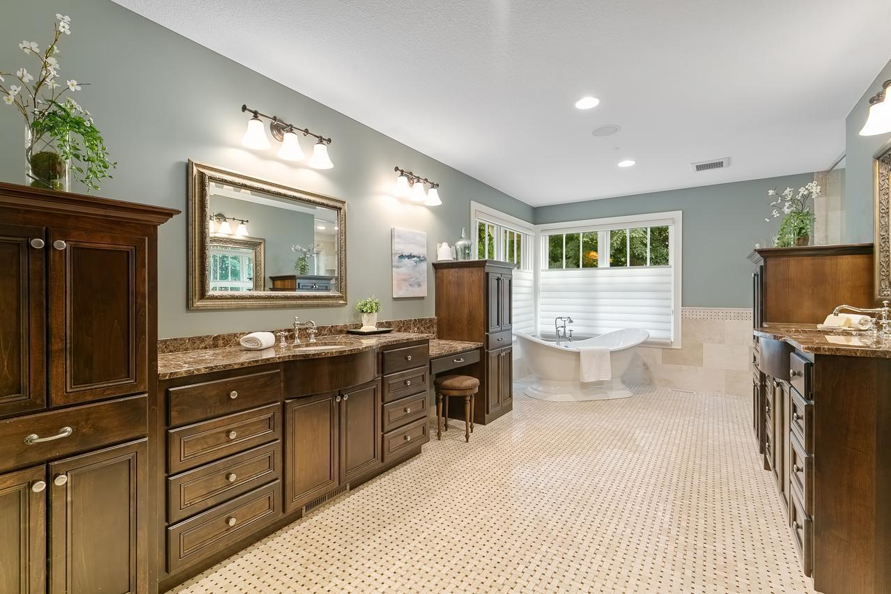 Gracious full primary bathroom with vanity and spa tub