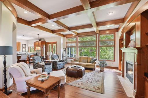 Main floor family room offers new hardwood floors, large windows, gas fireplace and custom celing woodwork