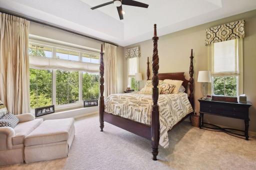 Main floor primary bedroom with new carpet and walk-in closets with custom shelving