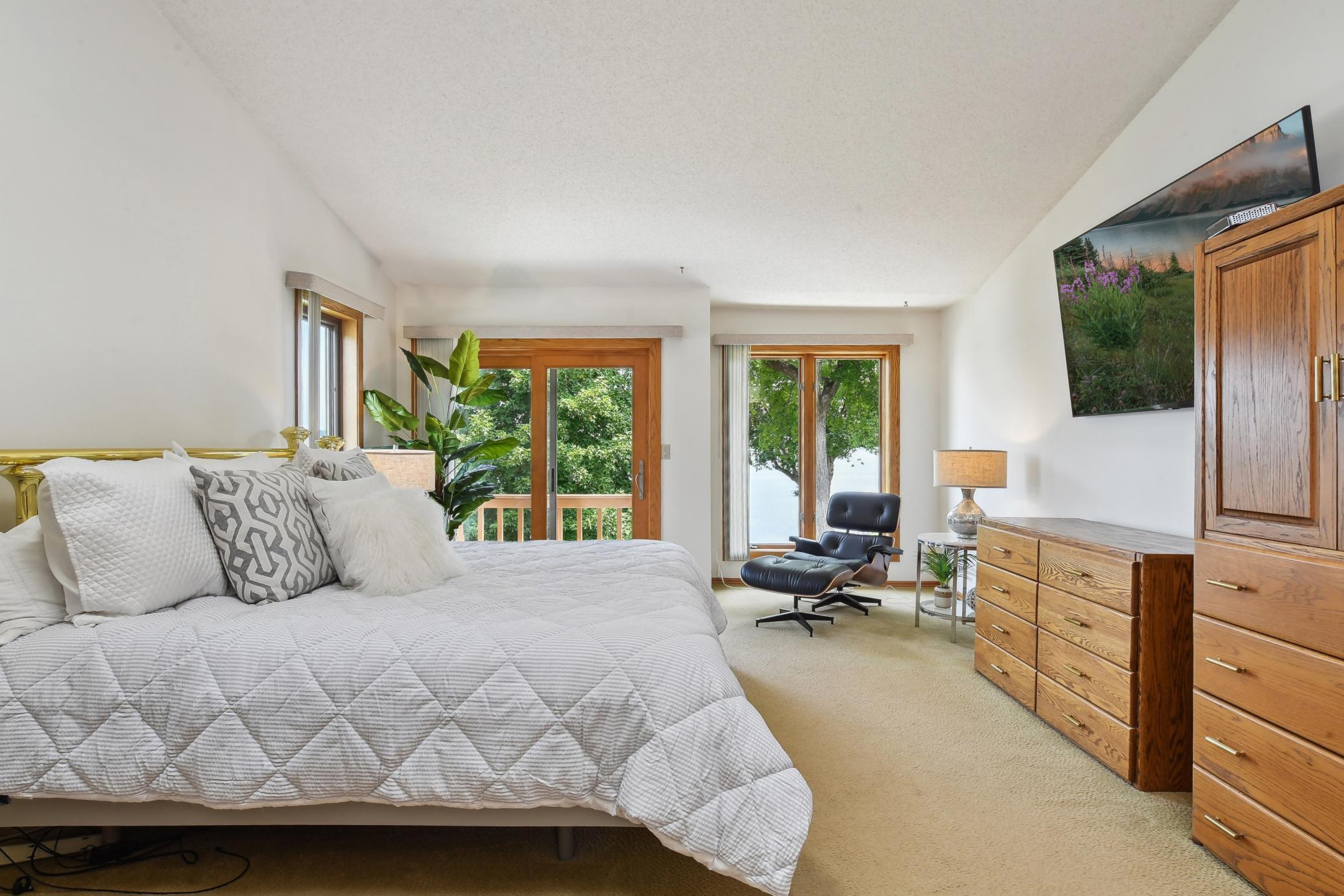 Master suite with vaulted ceilings and natural light and incredible lake views