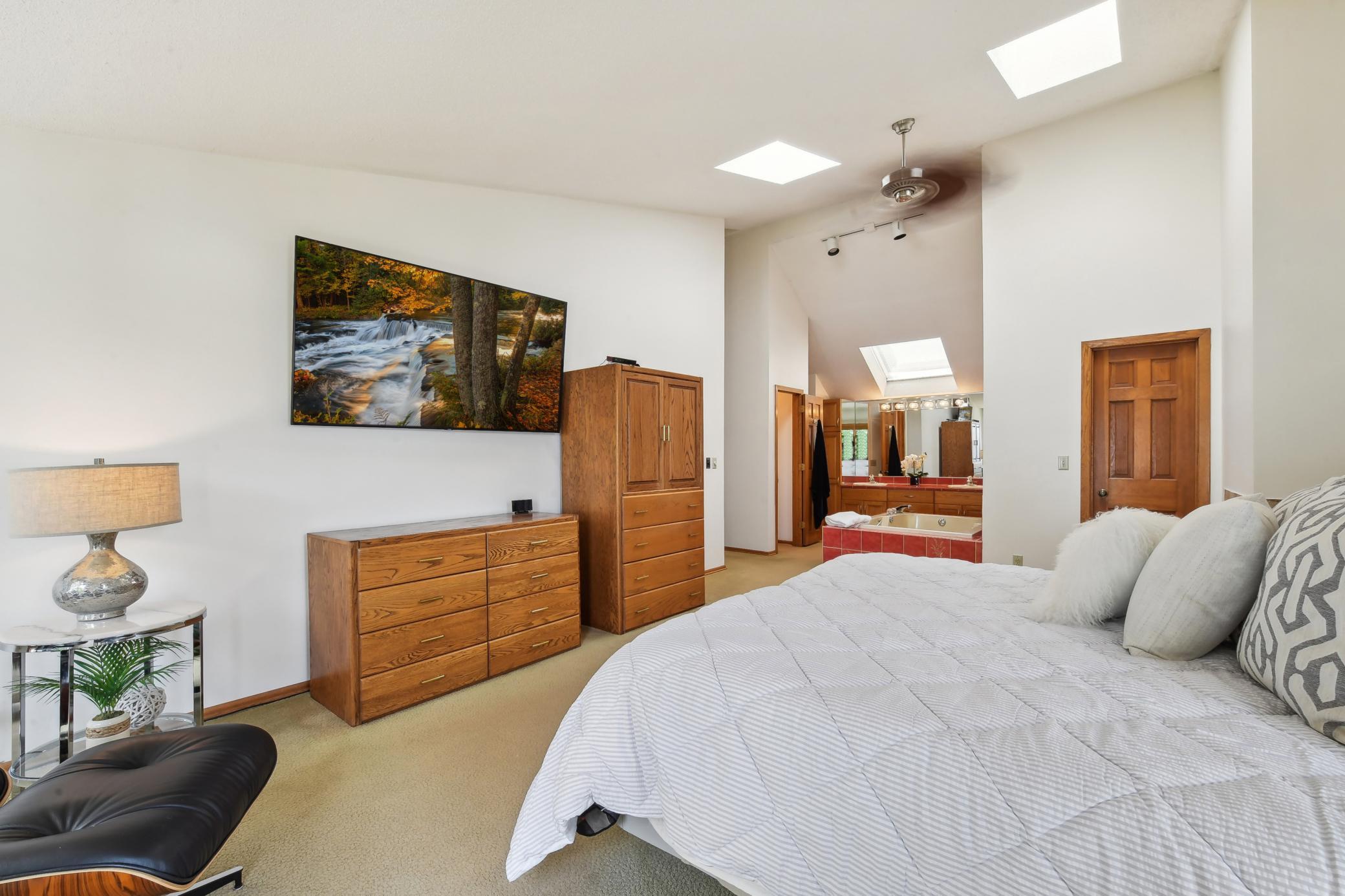 Master suite with vaulted ceilings and natural light