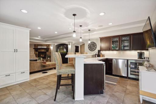 Wet bar features built in ice maker, dishwasher and 2 beverage fridges