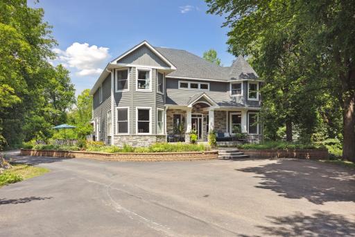 Large front parking area and garage is tucked behind the home