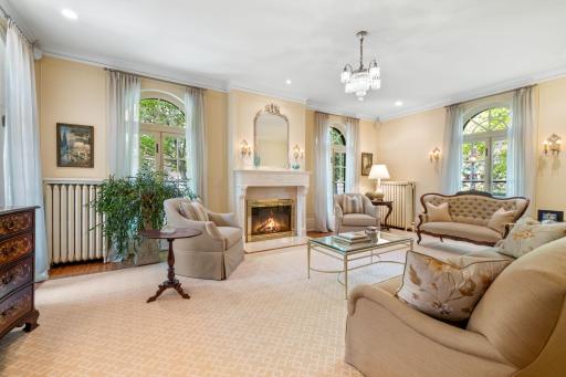 Grand Living Room with access to the Courtyard displaying one of the home's Seven Fine Fireplaces!