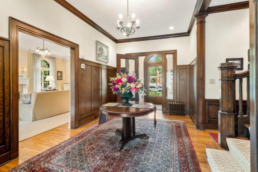 Welcoming Formal Foyer with Vestibule and Rich Oak Wainscotting