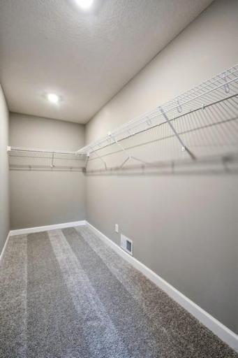 Walk in closet in primary bedroom! So much room! Photos of actual home for sale.