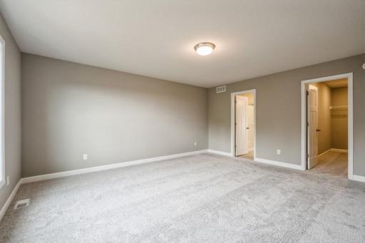 Large primary bedroom with walk in closet and ensuite attached. Photos of actual home for sale!
