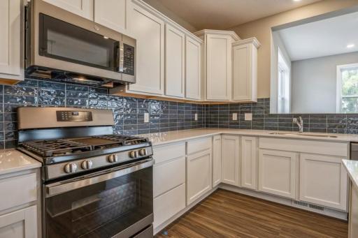 Check out that pop of color on the backsplash in this home! Photos of actual home for sale.