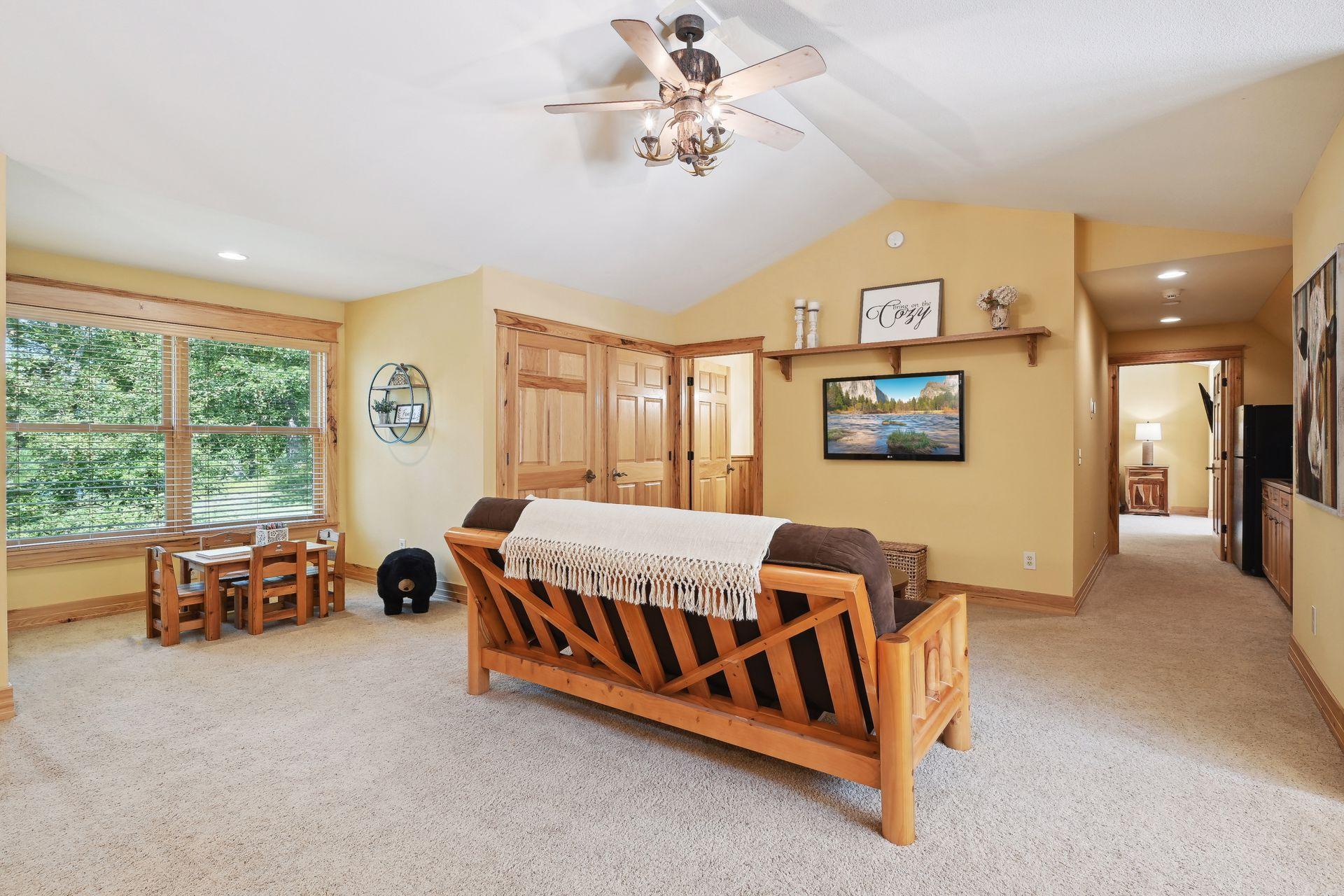 Head upstairs to the second guest suite. This is located over the heated garage. A perfect space for an entire family. It has a little play area for the kids.