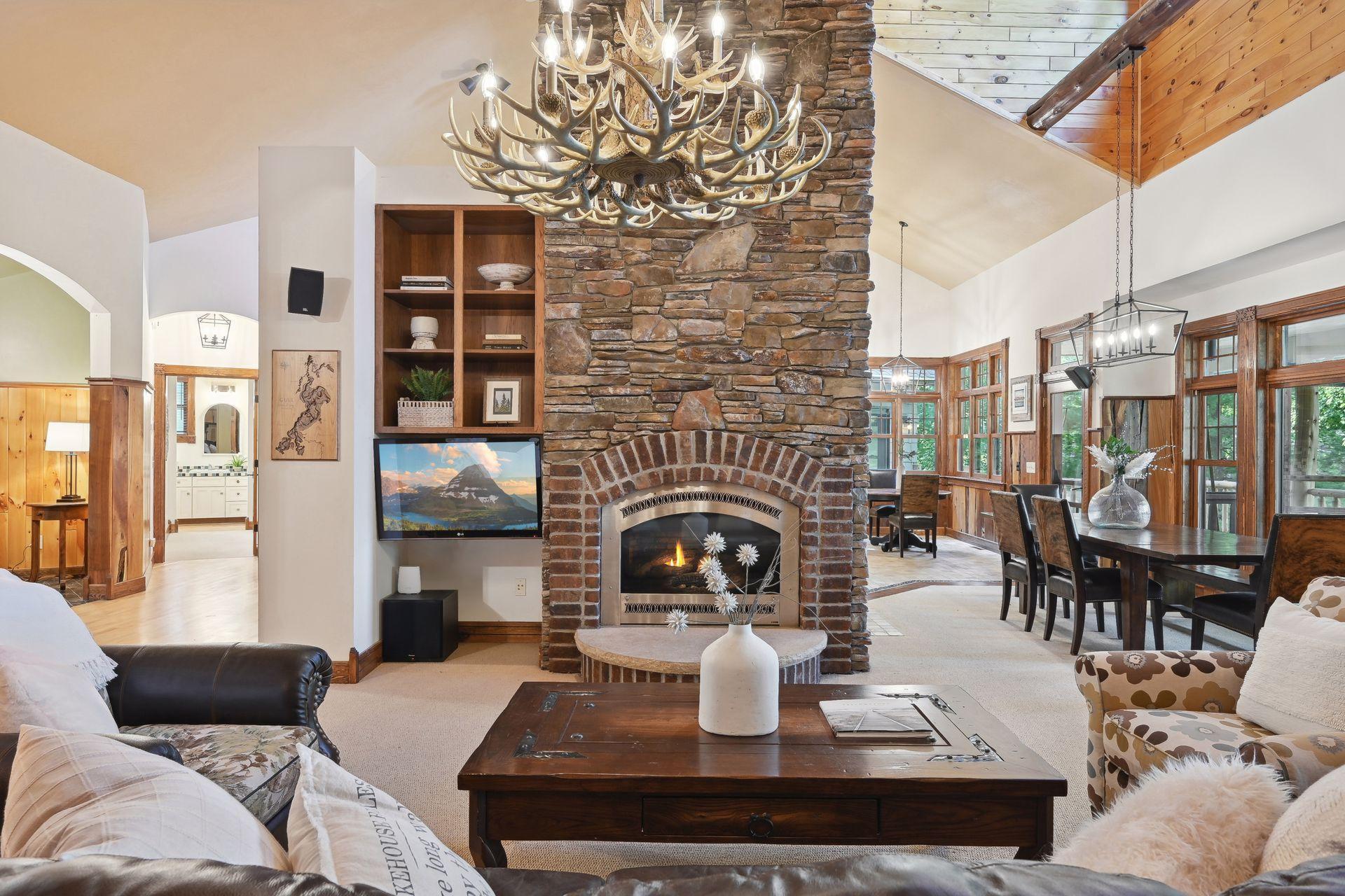 Relax indoors by the fire or step out onto the adjacent screened porch for views of the lake.