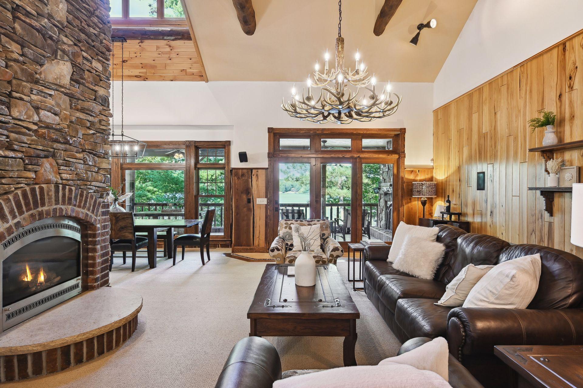 The two story stone fireplace features two fireplace heating elements to enjoy from the living room and dining area.