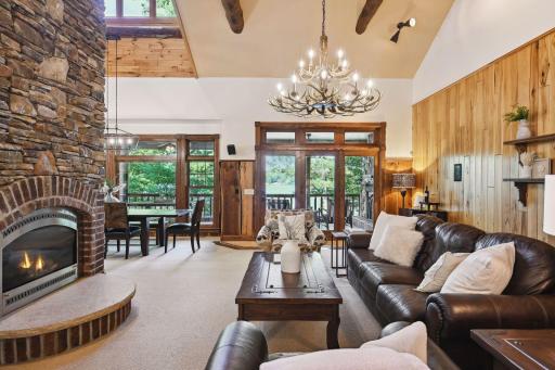 The two story stone fireplace features two fireplace heating elements to enjoy from the living room and dining area.
