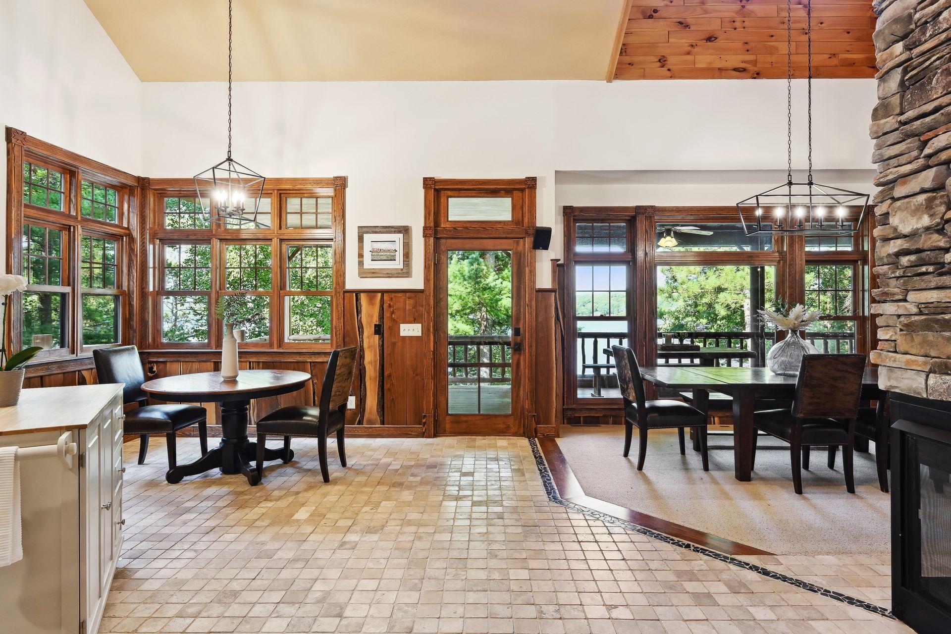 The in kitchen dining area has space for overflow and steps out to a deck overlooking the expansive backyard and lake views.