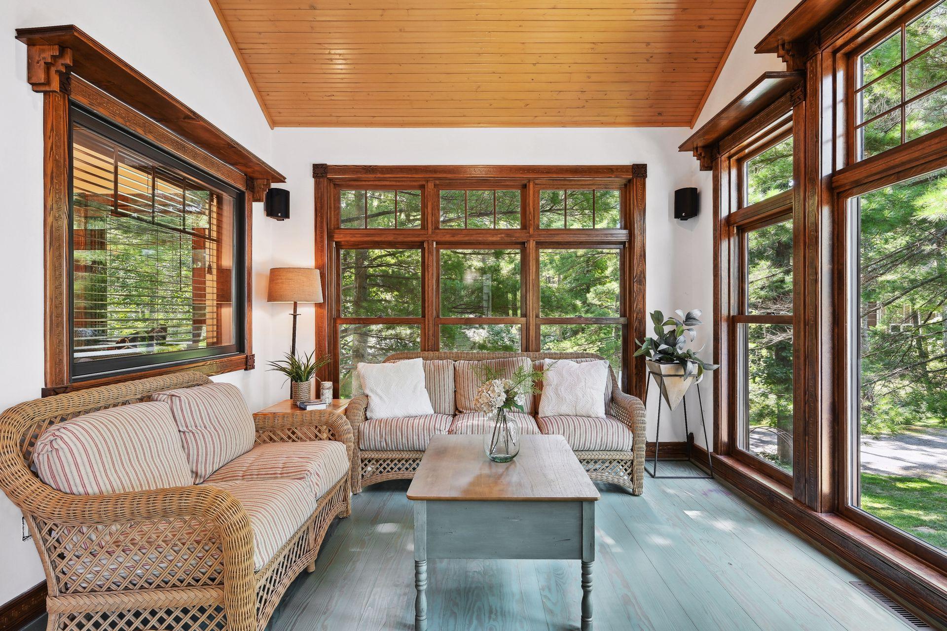 Let the sunshine in! This cozy porch is surrounded by windows, trees and views from every angle.