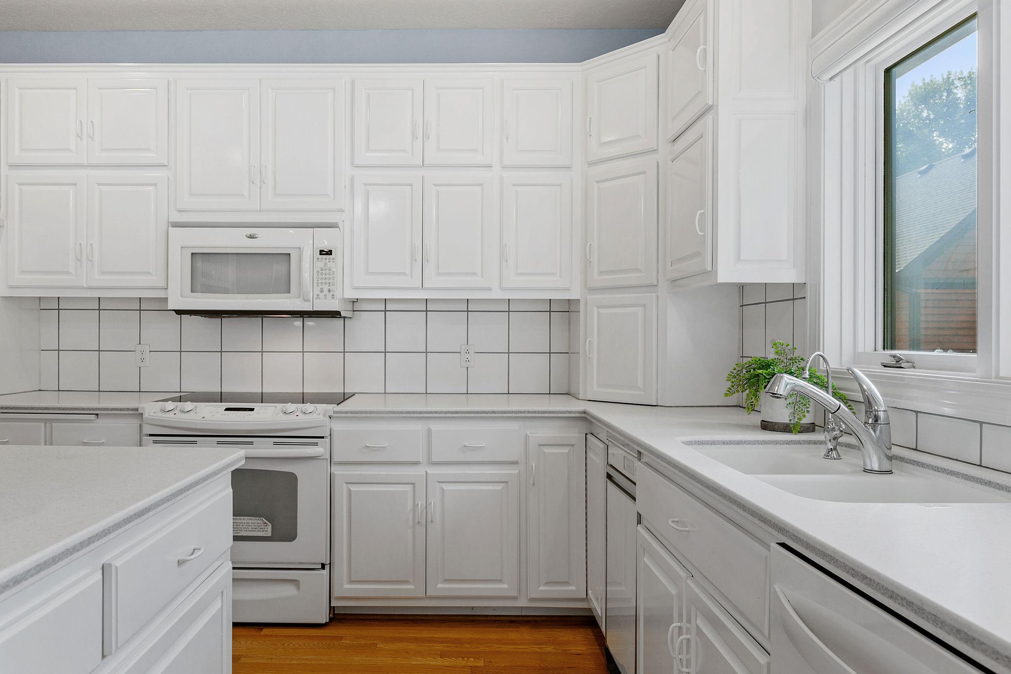 Solid surface countertops w/ decorative tile backsplash