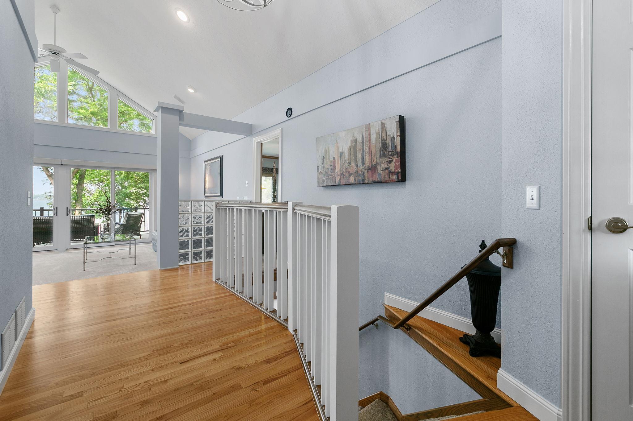 Open staircase w/ modern railing & instant views of Lower Prior Lake