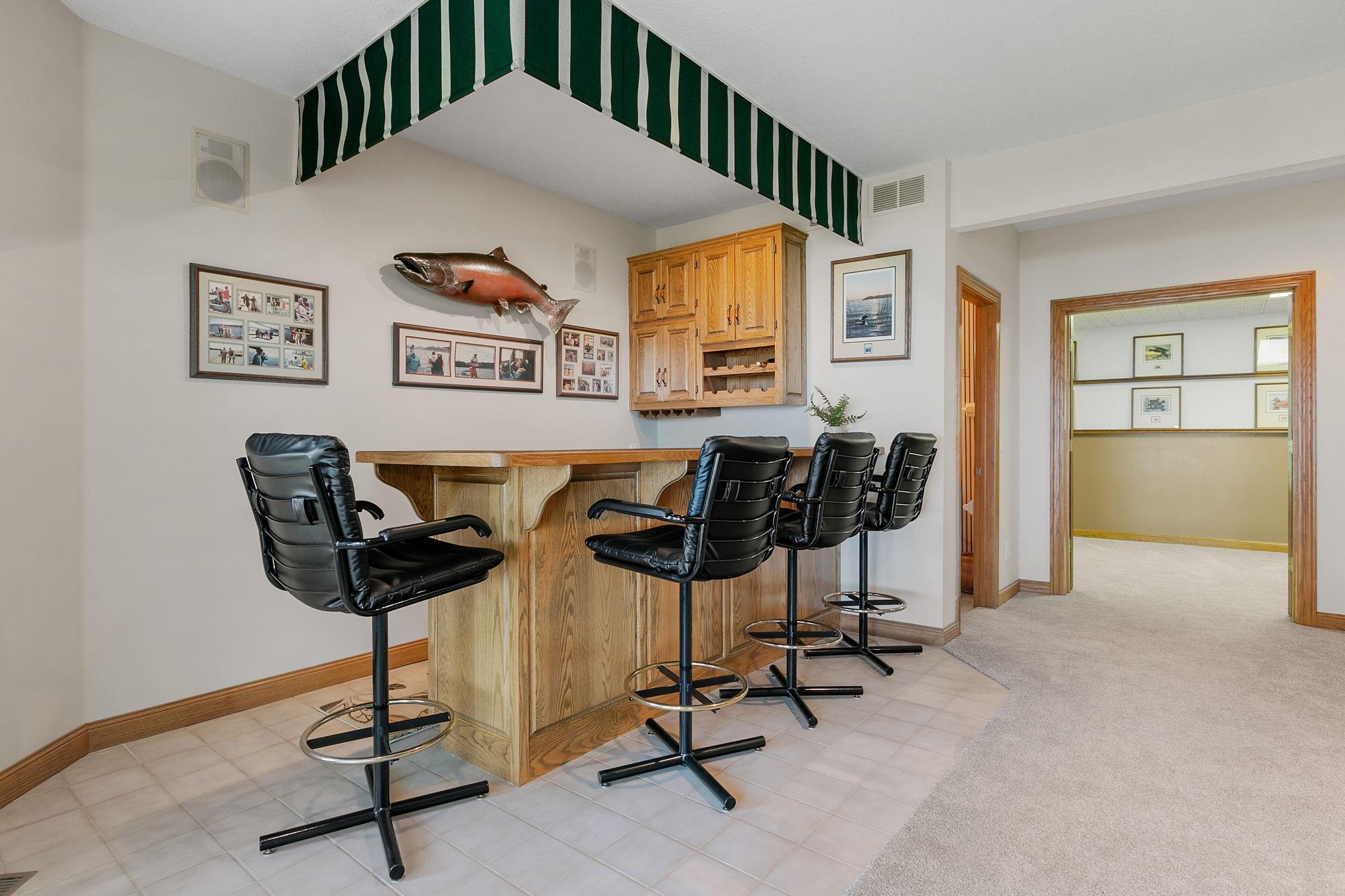Built-in oak bar w/ ceramic tile flooring