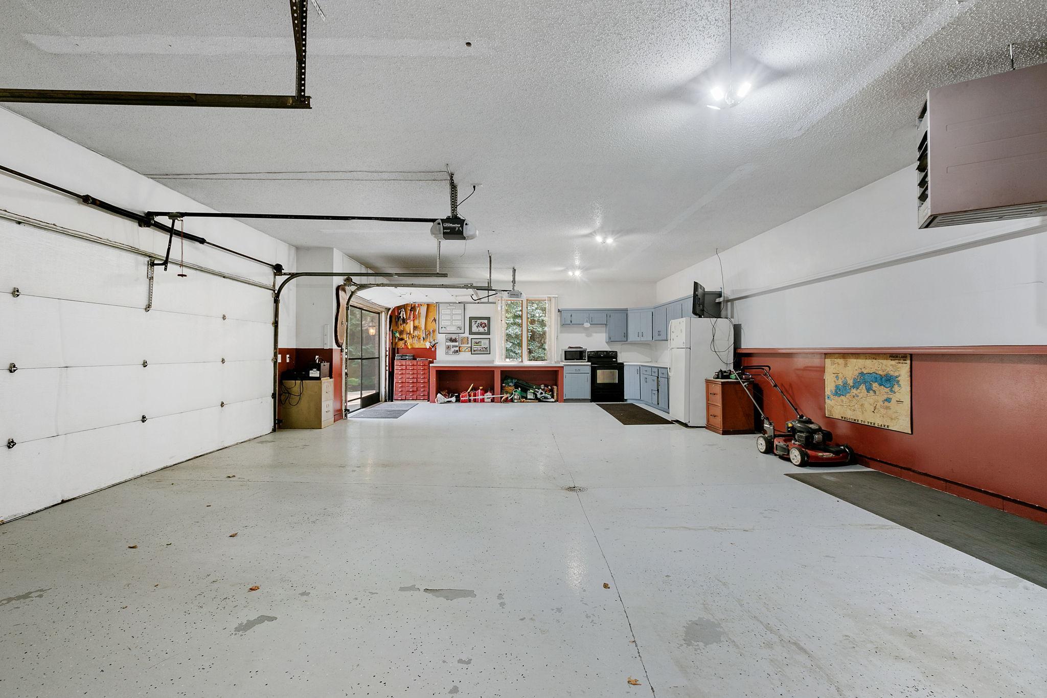 Finished and heated an oversized 3 car garage. Features include epoxy coated floors w/ drain, built-in storage shelving and entry door w/ access to the property