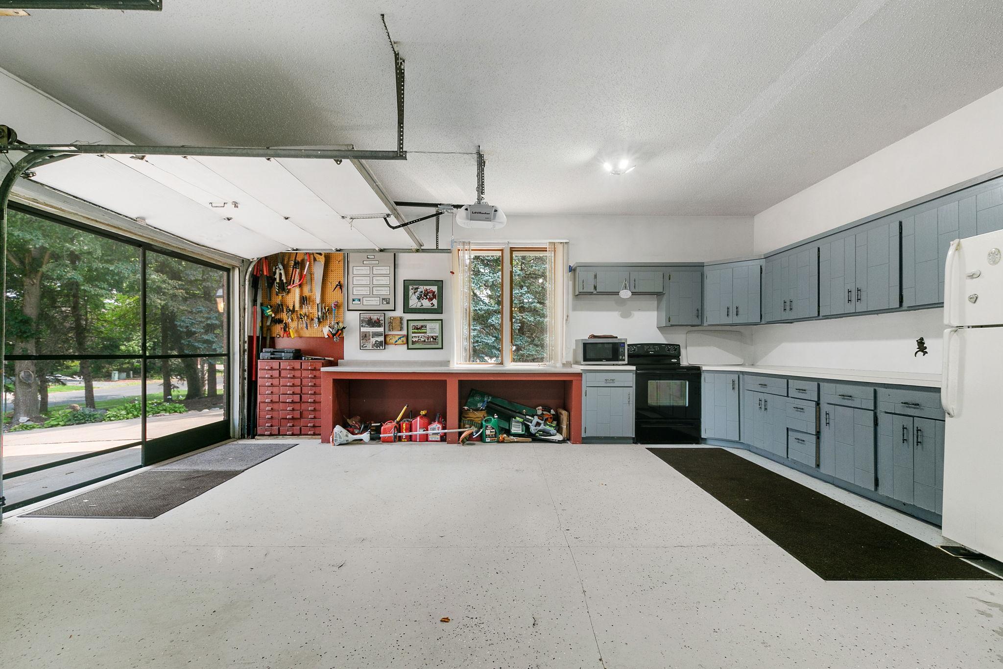 Built-in cabinetry, electric range and refrigerator provides a secondary kitchen area