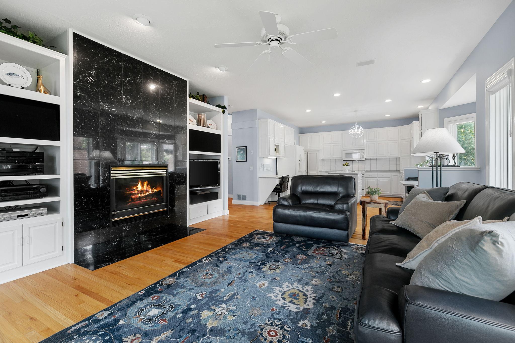 Gas fireplace w/ floor to ceiling polished stone surround and hearth. Family Room also offers built-in enameled entertainment cabinets which feature open area for a TV, speaker panels, storage and open display shelving