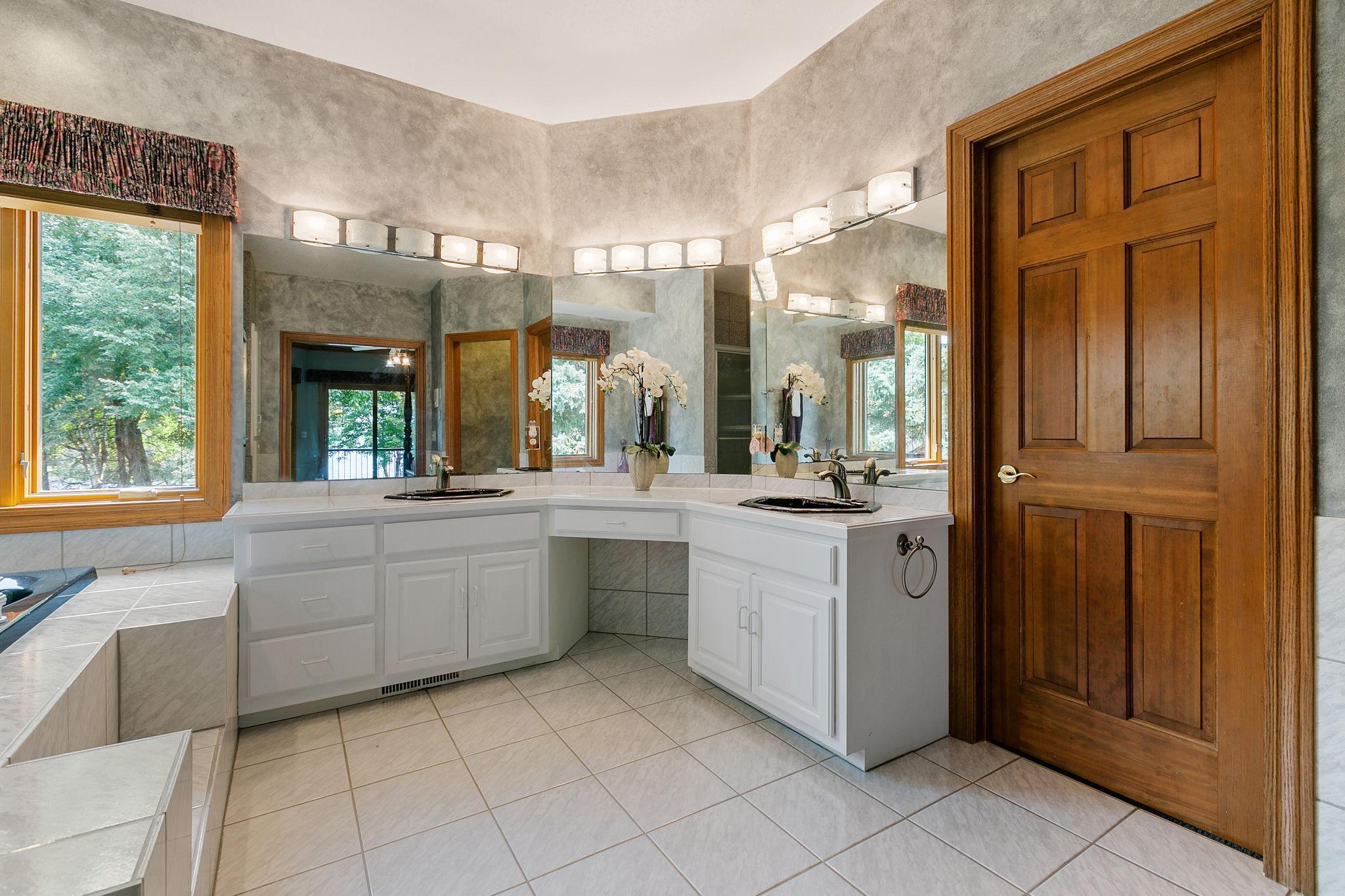 Master Bathroom features dual enameled vanities and makeup counter