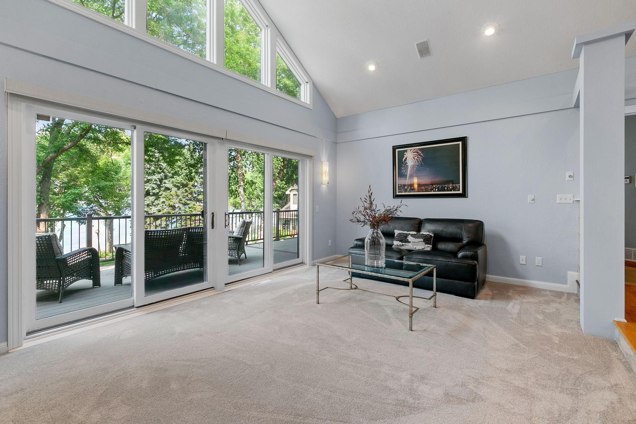 Dual full glass patio doors w/ access to the maintenance free deck & property
