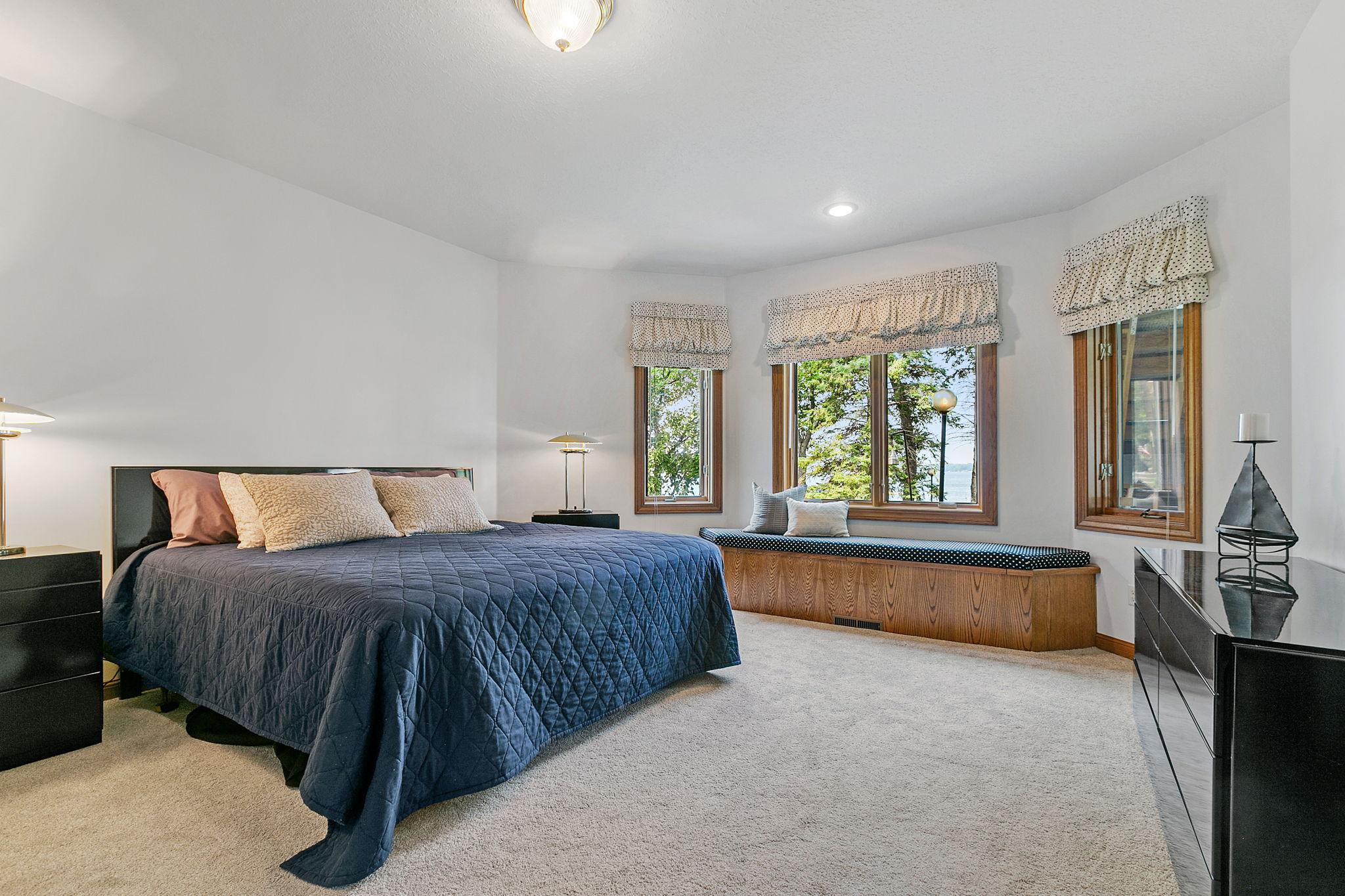 Lower level 2nd Bedroom features a large bay window with a built-in bench/storage and offers fantastic lake views!