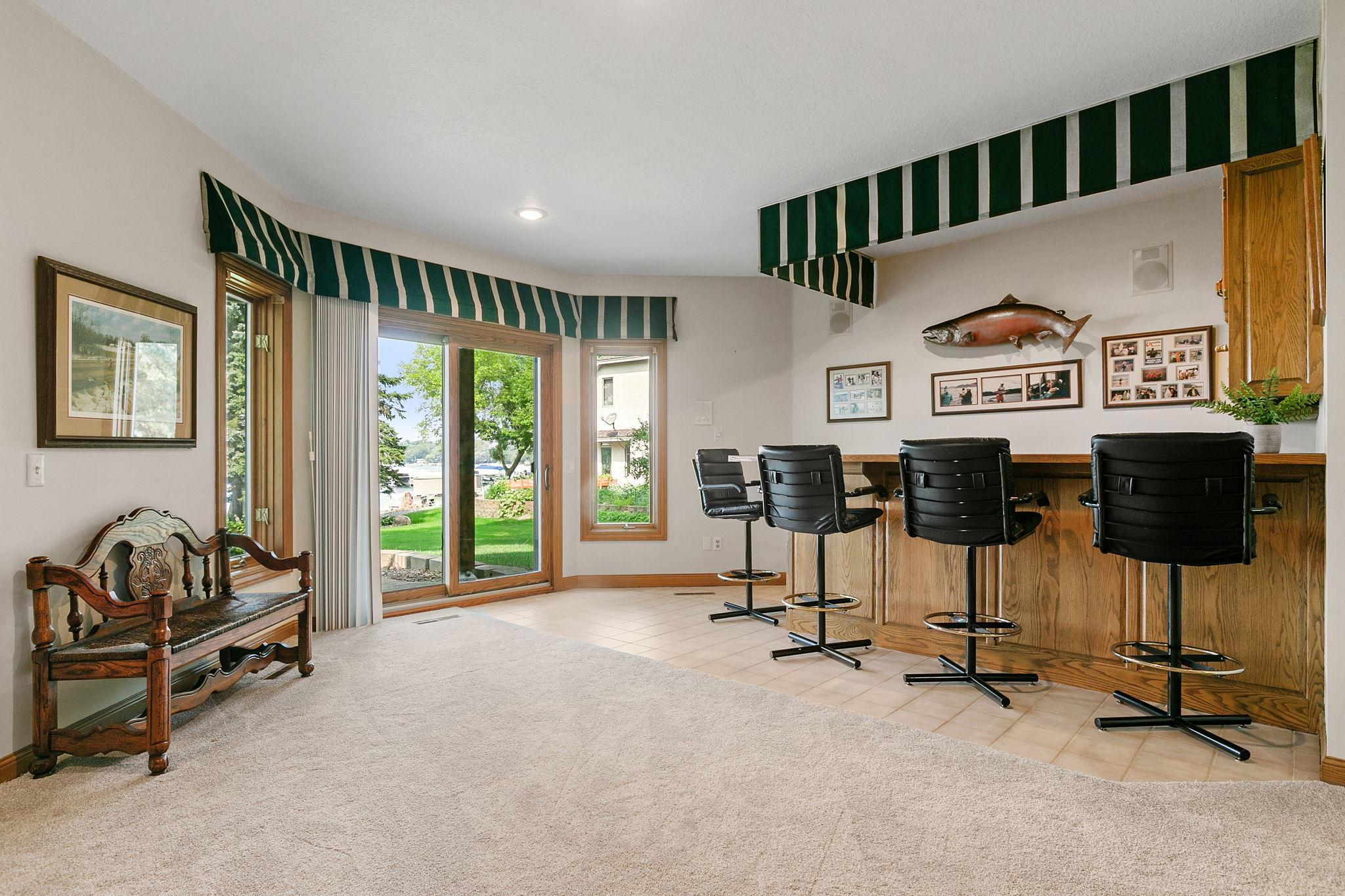 Bay window boasts a patio door w/ access to the lower level patio and offers incredible lake views
