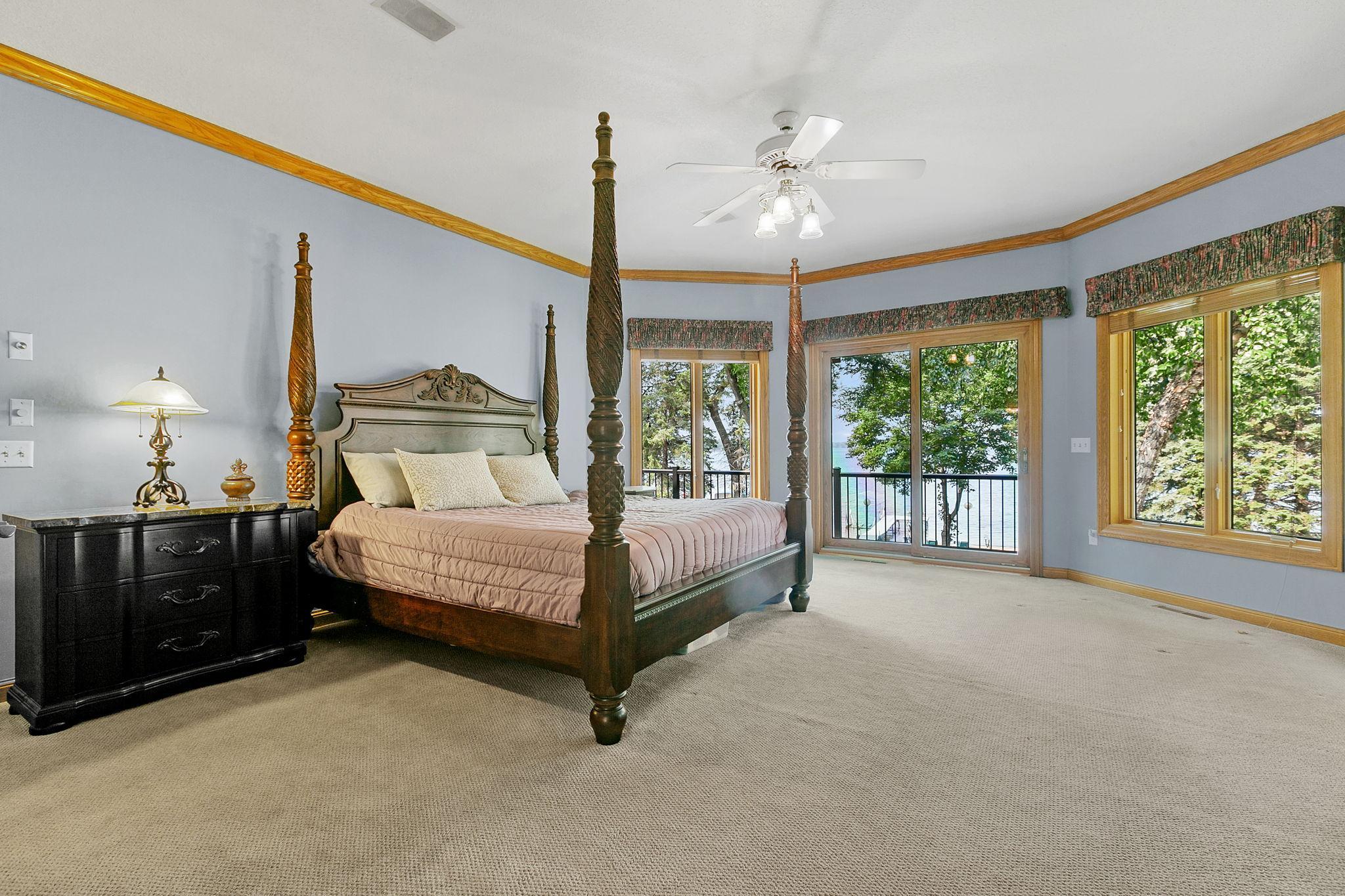 Main Level Master Suite is spacious in size and offers a bay window w/ full glass patio doors which provides access to the deck and property