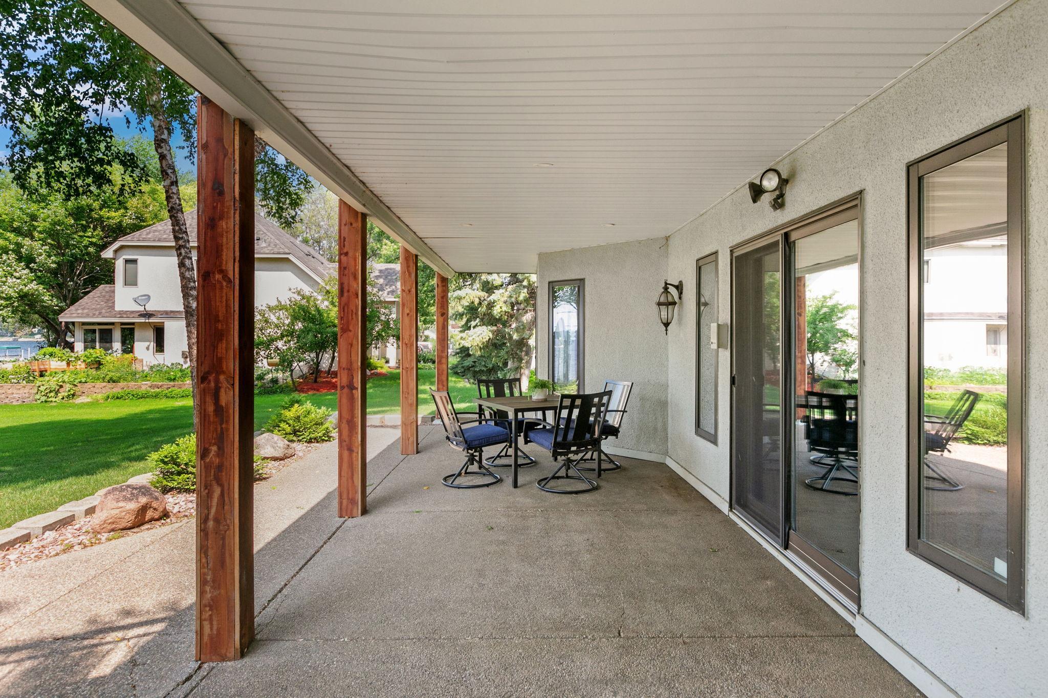 Lower Level aggregate patio mirrors the size of the upper deck and is completely covered, underdecking is installed under the main deck
