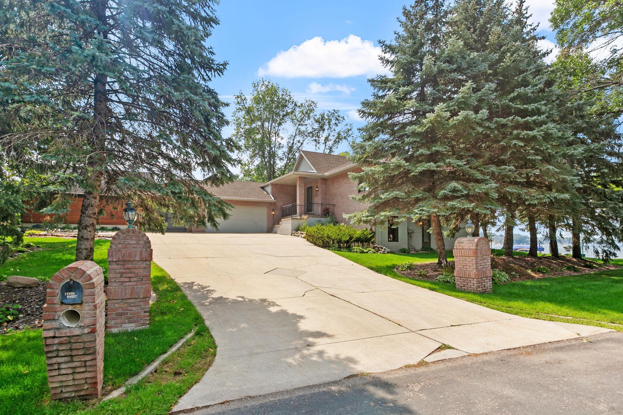 This stunning walkout rambler offers nearly 100 feet of captivating and level lakefront living.