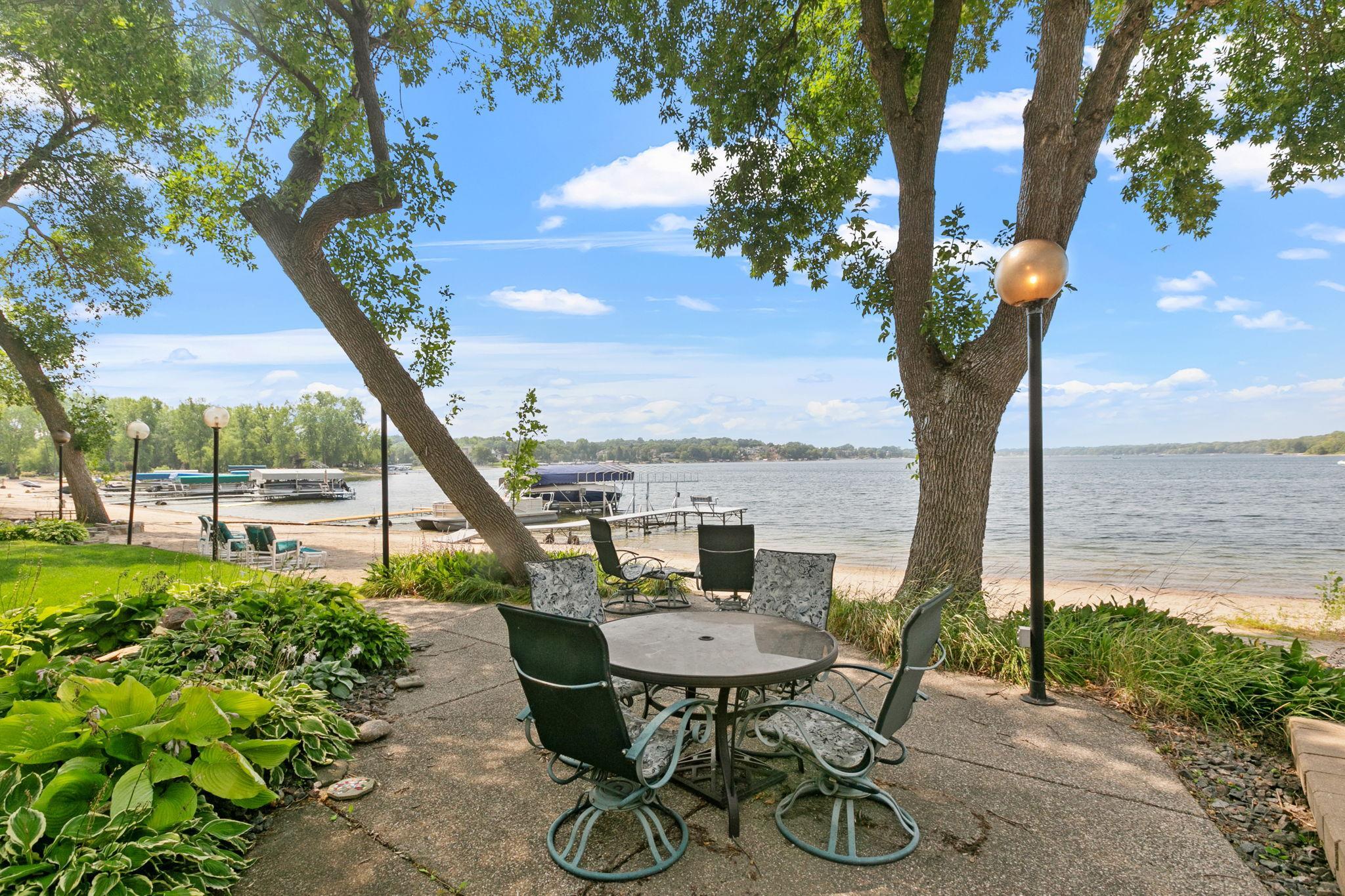 Lakeside aggregate patio is situated in a garden just off of the beach