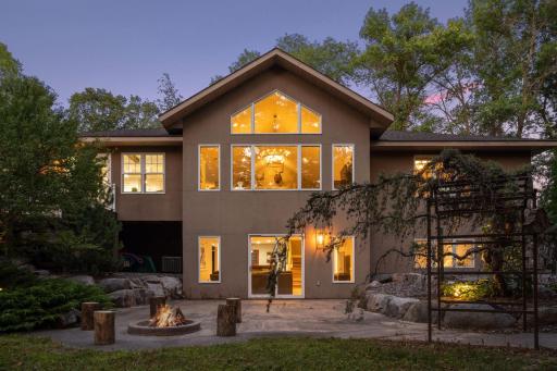 Large back patio with firepit and incredible landscaping
