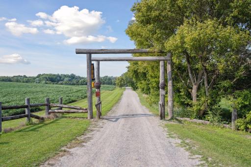 Dual arch marks the entrance to the 0.4 mi driveway
